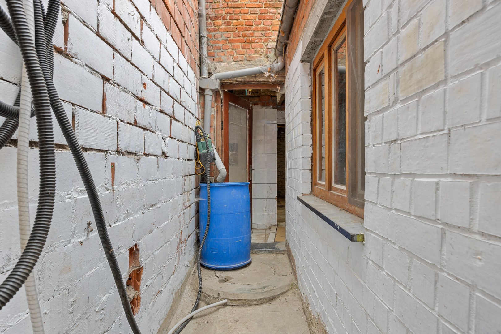Halfopen hoekwoning met garage en dakterras op toplocatie in Kessel-Lo – renovatieproject met veel potentieel 