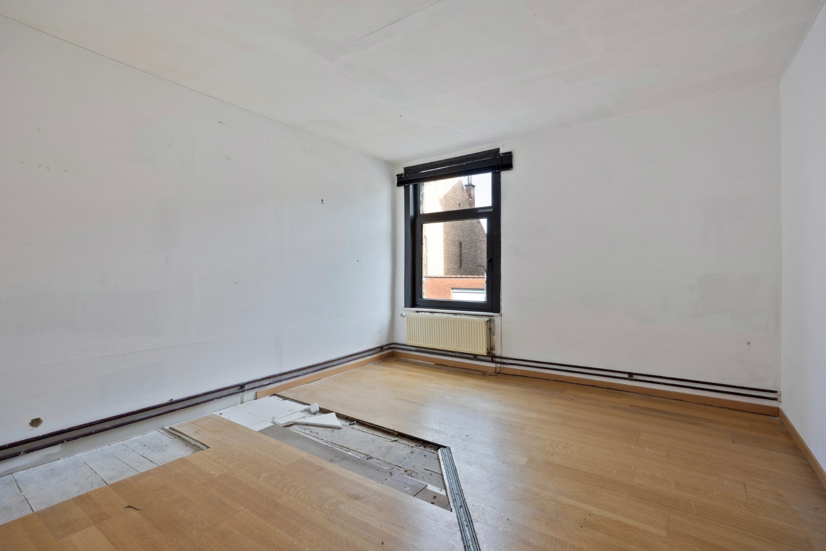 Halfopen hoekwoning met garage en dakterras op toplocatie in Kessel-Lo – renovatieproject met veel potentieel 